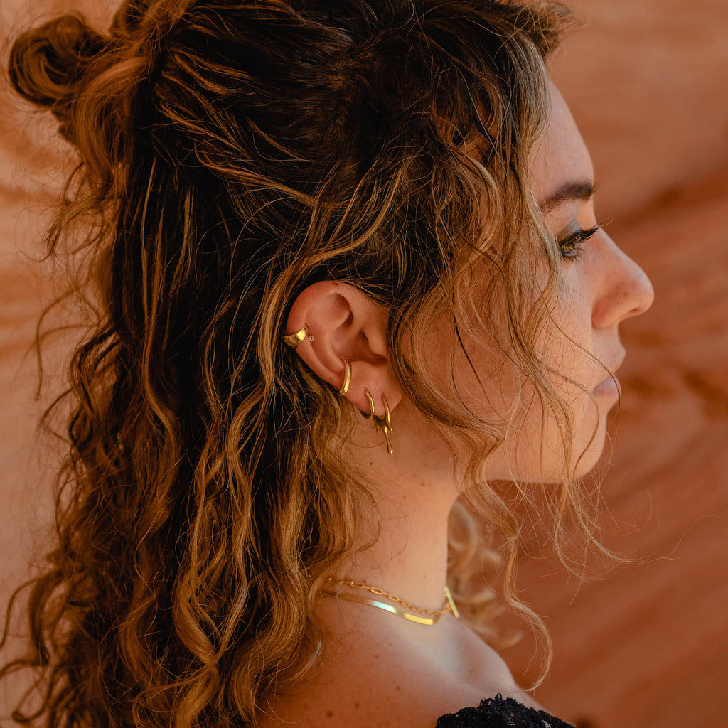 Close up of Model in Red Desert wearing 18k gold plated 925 Sterling Silver ‘Classic Ear Cuff’ Styles ‘A’ and ‘B’ and “MARIE JUNE Jewelry’ Designs